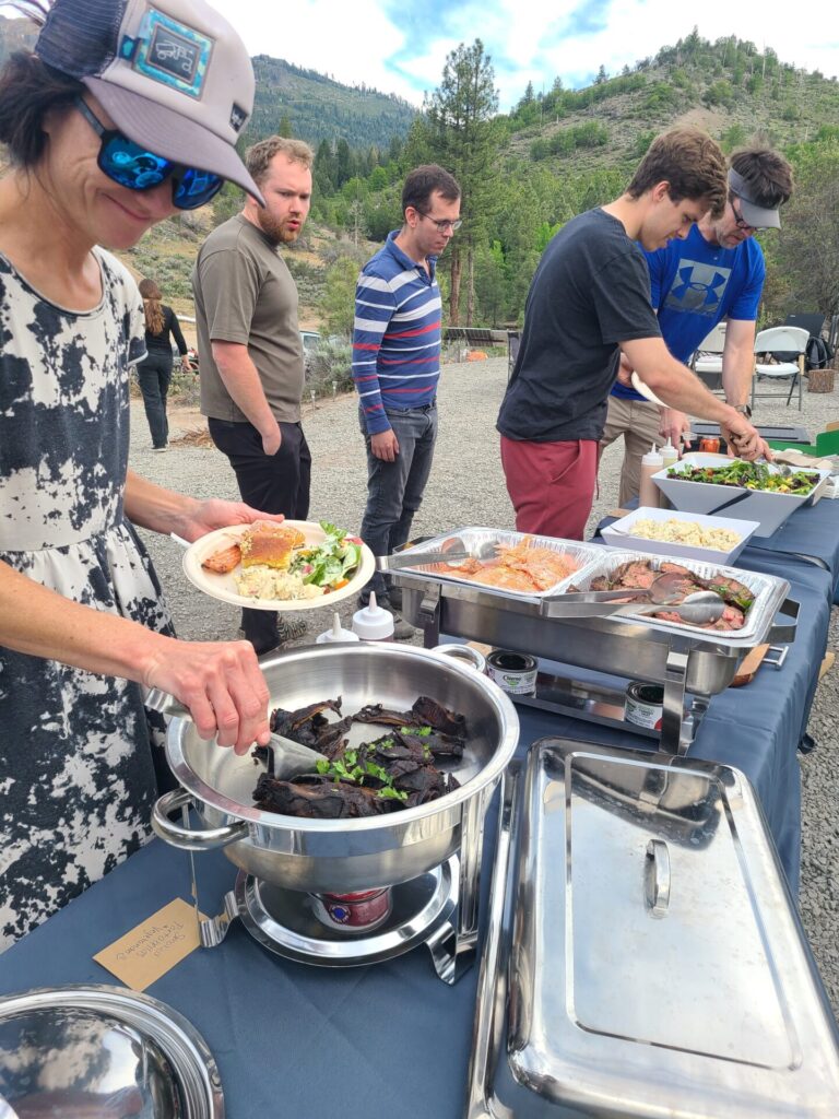 Riders serving themselves from the catered dinner buffet at High Camp
